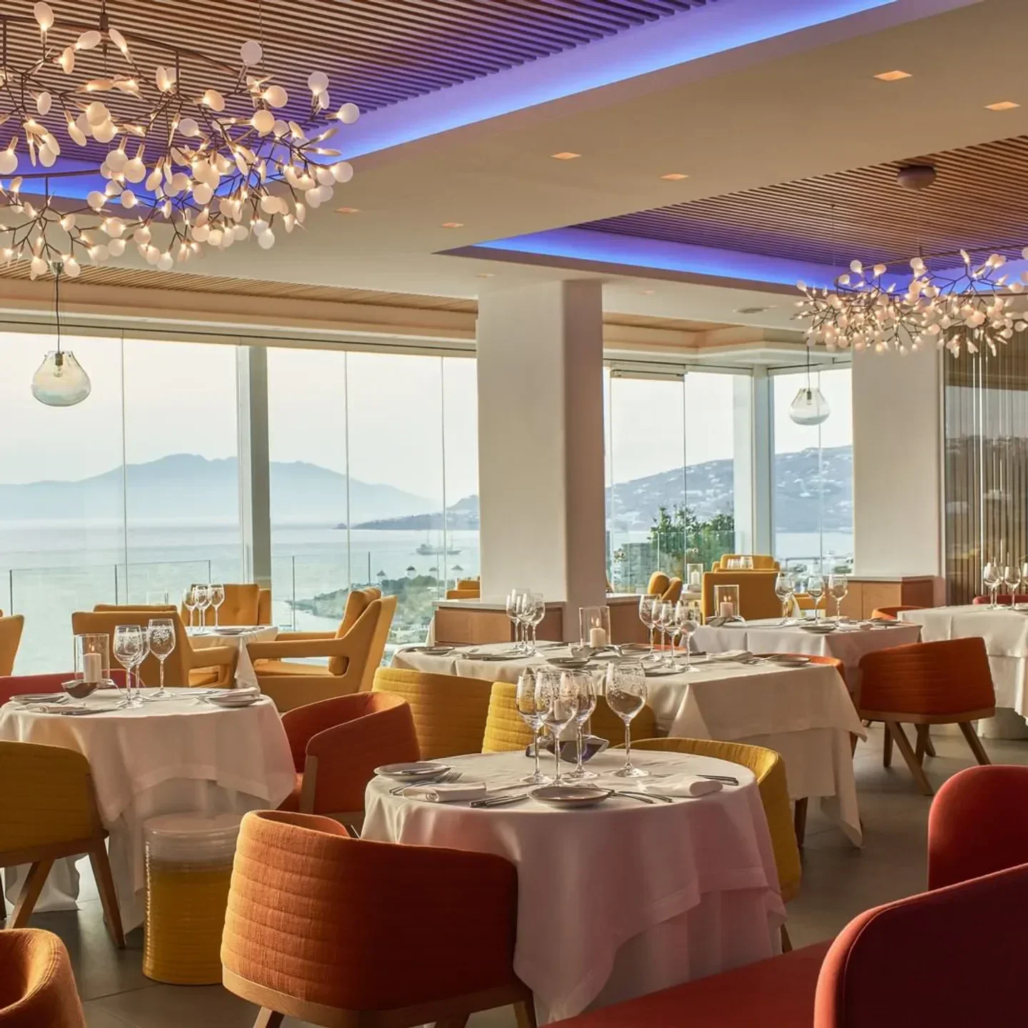 Elegant dining room at Baos restaurant in Mykonos, featuring sea views and stylish decor.