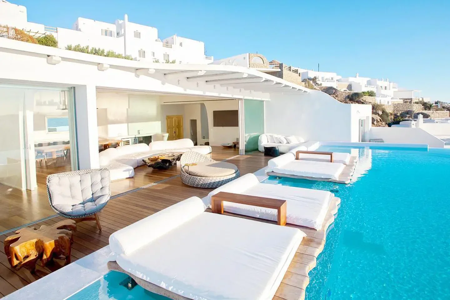 Cavo Tagoo Mykonos beach club with pool, sunbeds, and stunning white architecture