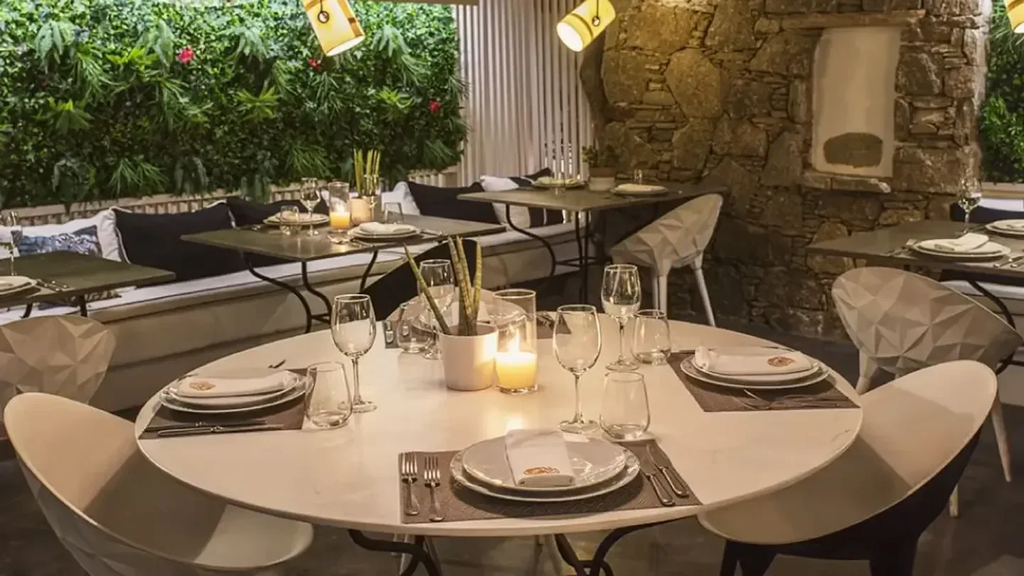 Cozy dining area at Krama restaurant in Mykonos, featuring stylish decor and ambiance.
