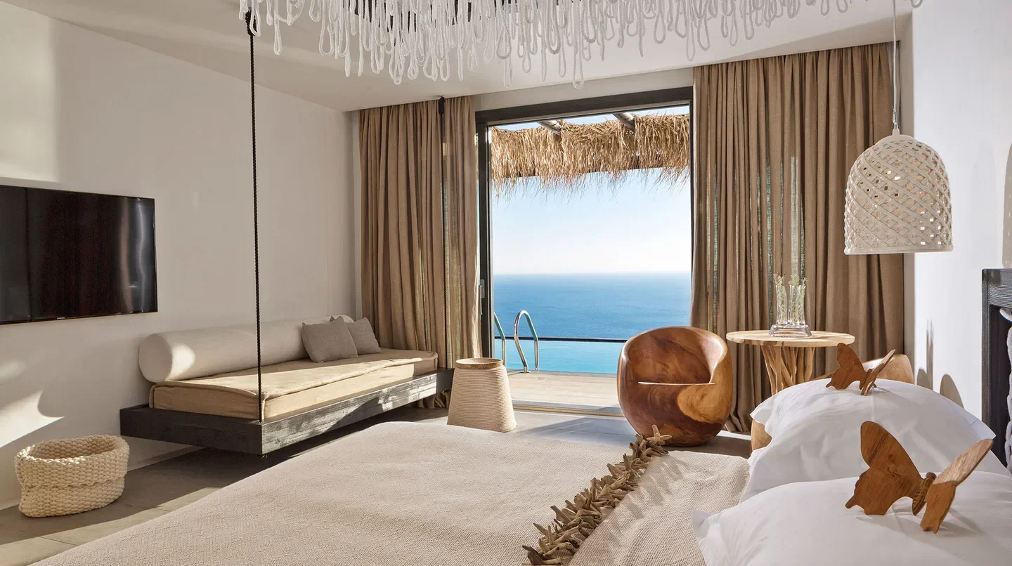 Seaside bedroom at Myconian Utopia, Relais & Chateaux, Mykonos, with ocean views and pool access.