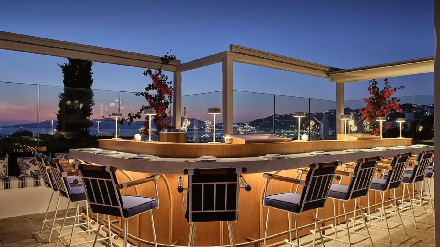 Stylish bar at Nobu Mykonos, featuring evening views over the city.