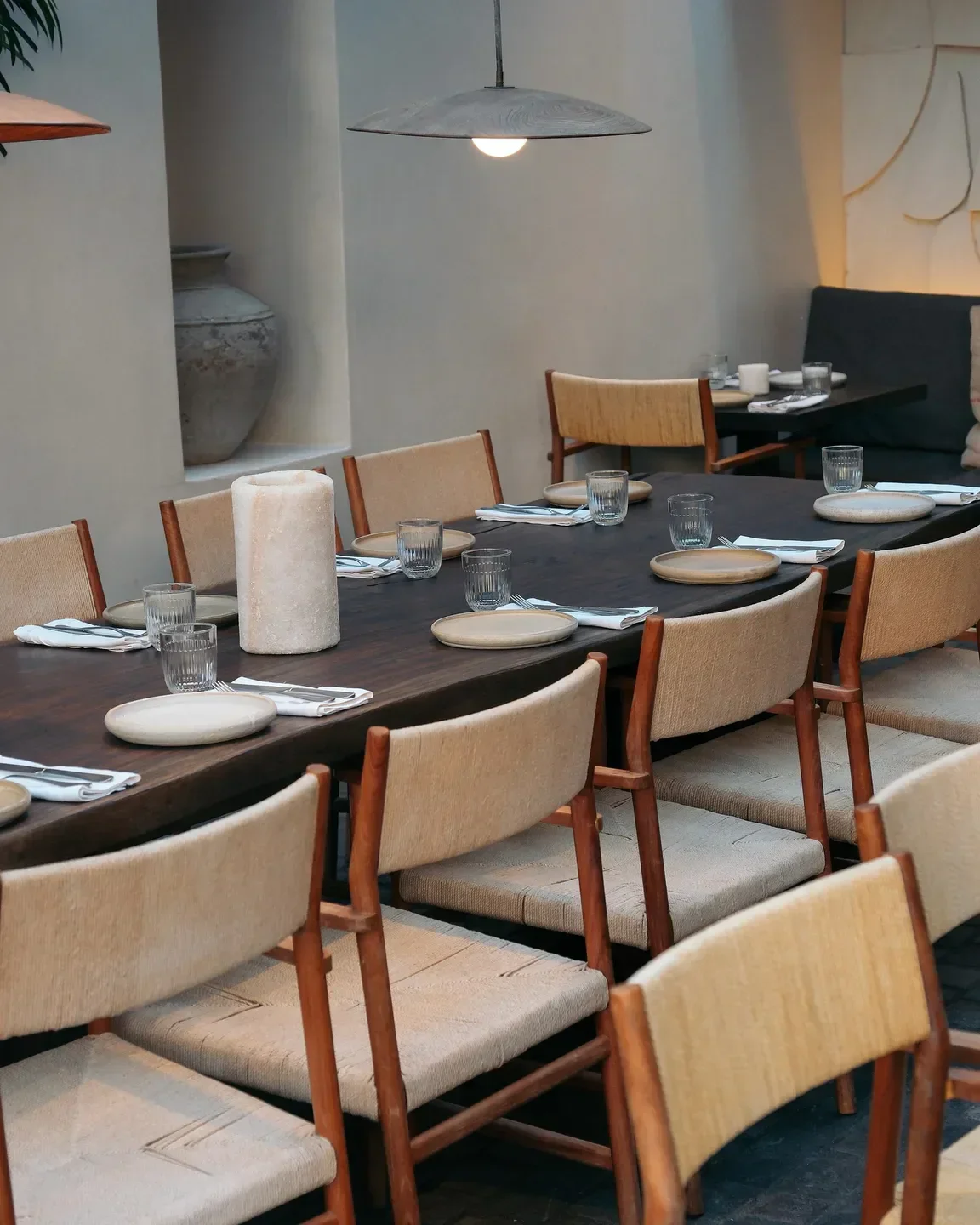 Dining setup at Noema restaurant in Mykonos, showcasing elegant tables and chairs.