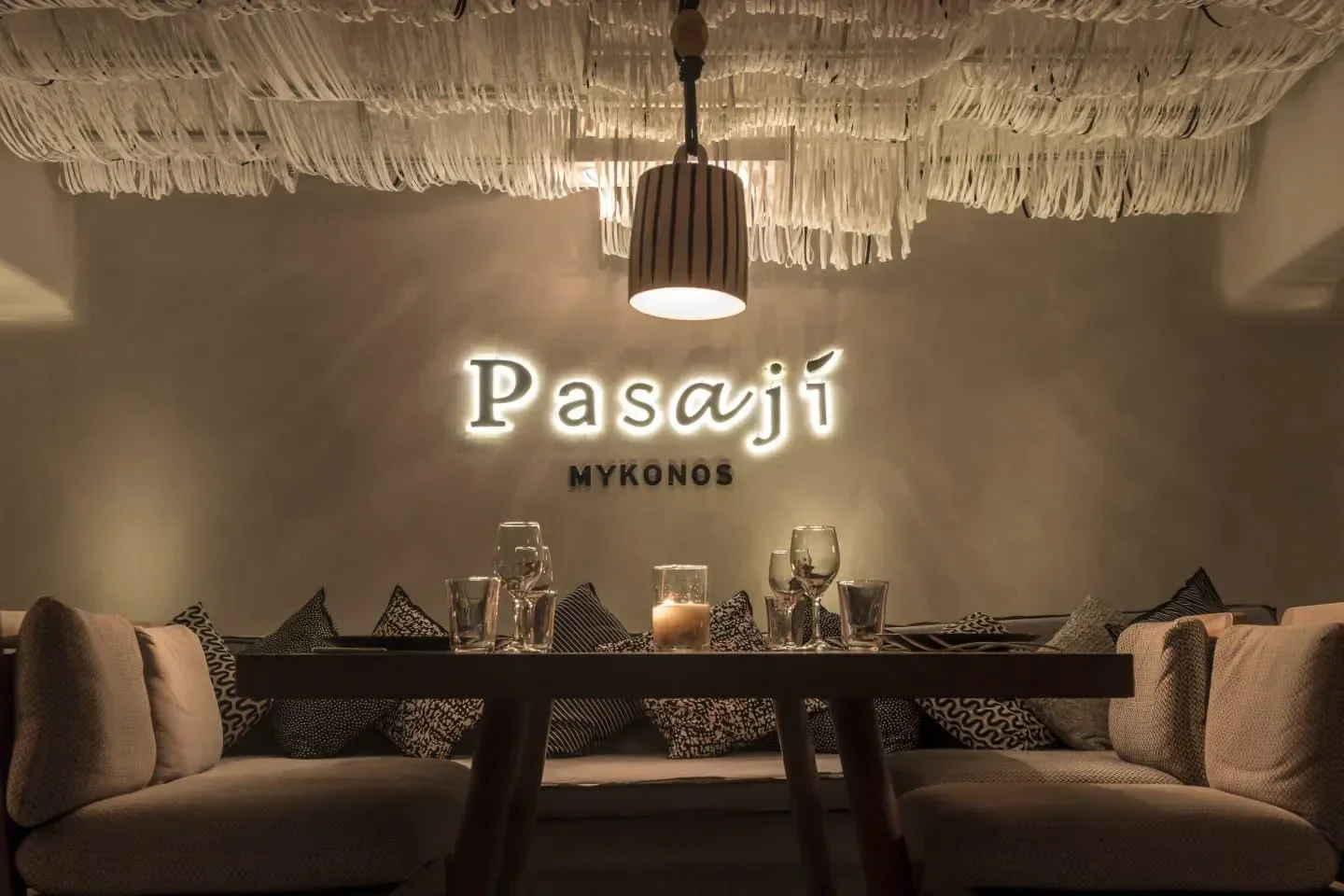 Cozy dining area at Pasaji Mykonos, featuring stylish decor and ambient lighting.