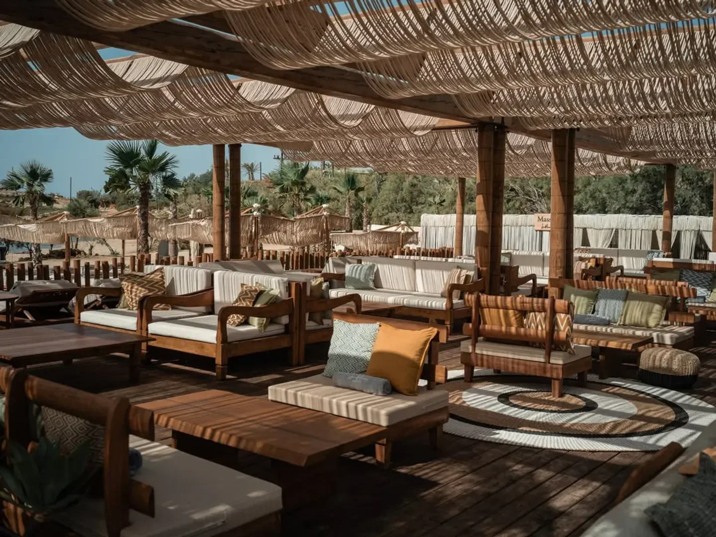 SantAnna Mykonos outdoor restaurant with wooden furniture and stylish design