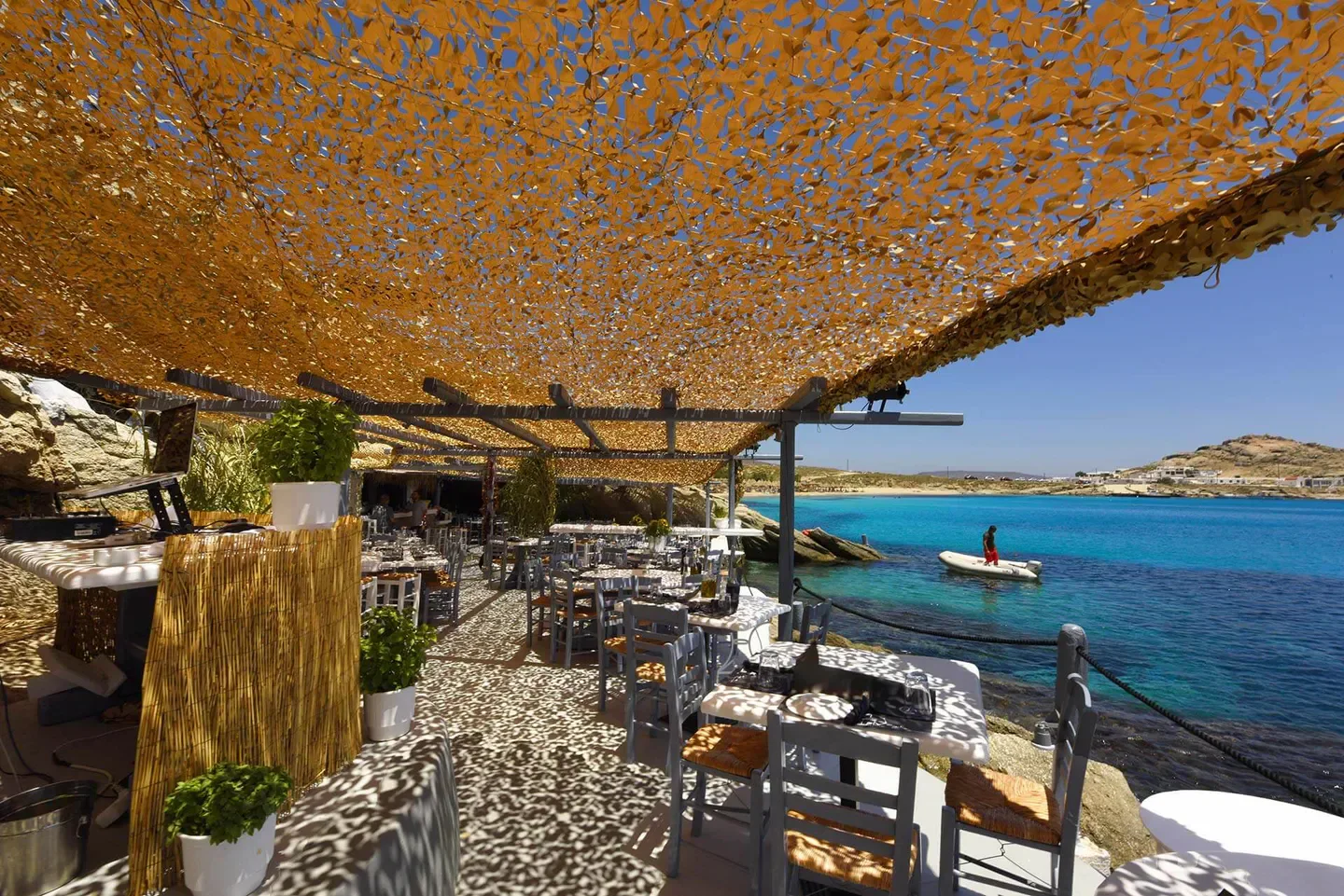 Spilia restaurant in Mykonos, shaded tables with a stunning view of the turquoise sea