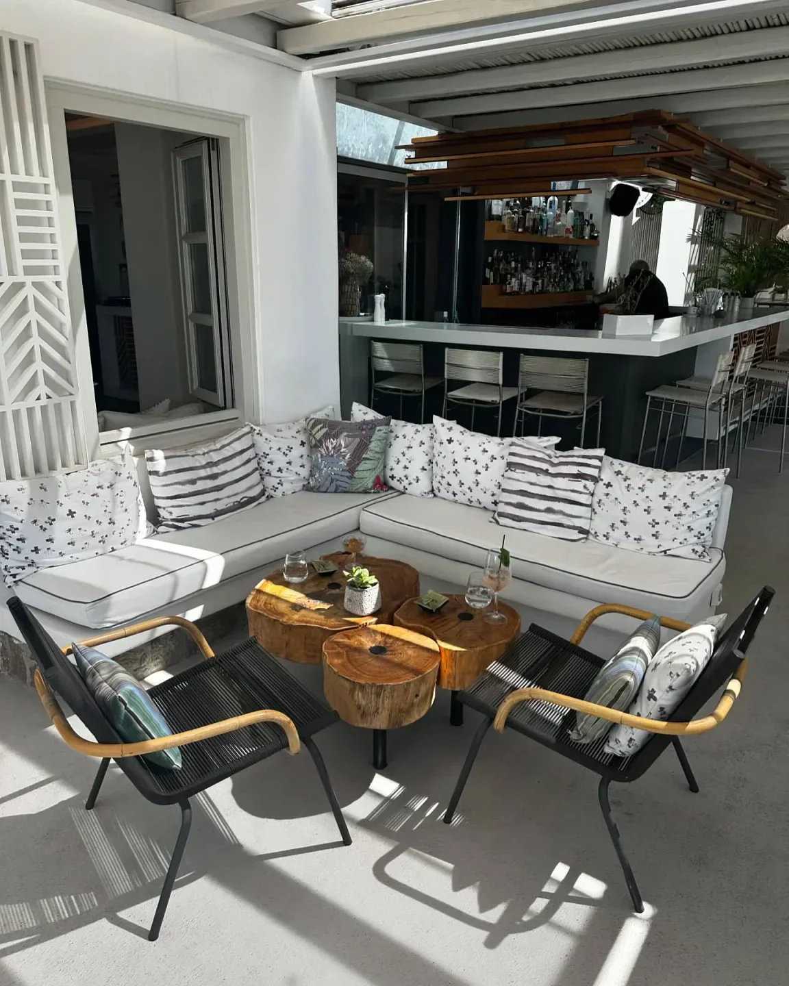 Outdoor seating and bar area at Thioni restaurant in Mykonos, Greece.